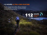 A hiker on a lit lakeside trail uses the Fenix Lighting HL12R V2.0 headlamp, featuring SST20 white & 2835 red LEDs, rechargeable design, 112-hour ultra-long runtime, and an impressive built-in battery for worry-free adventures.