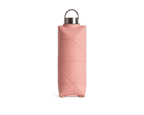 The DiFold Origami Bottle by Difold is a pink, geometric-patterned collapsible water bottle made from plant-based polymer with a silver screw-top lid, shown upright on a white background.