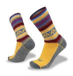 A pair of yellow and grey Wilderness Wear Merino Fusion Max Socks with colorful patterns, including stripes and geometric designs, featuring Climayarn technology and a reinforced heel and toe, displayed against a plain white background.