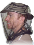 A man traveling with a 360 Degrees hat equipped with a mosquito net to protect against insect-borne illnesses.
