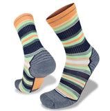 A pair of Wilderness Wear Merino Fusion Light Socks with hues of orange, green, navy blue, gray, and white. These cushioned hiking socks from Wilderness Wear feature a ribbed texture, reinforced heel and toe areas, and elasticated arch support for added comfort on your adventures.