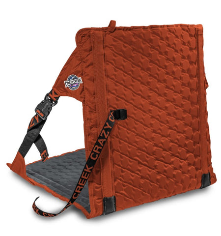 Crazy Creek Orange folding sit pad with black straps, made from ripstop nylon, labeled "creek crazy" and "trail seeker," designed for outdoor use.