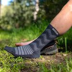 A person wearing Injinji Outdoor Midweight Crew height Merino wool socks in the woods.