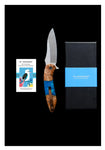 The "Kyle" Kookaburra EDC Pocket Knife by Koi Knives, featuring a distinctive wooden handle with an eagle design, elegantly displayed with its box and informational card on a sleek black background—ideal for enhancing your everyday carry collection.