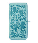 Introducing the Mont Flora Microfibre Travel Towel by Mont: a light teal travel towel adorned with a dark teal floral pattern and various botanical designs. It features a convenient loop for hanging and is made from 100% recycled materials, making it an eco-friendly, quick-drying accessory perfect for any adventure.