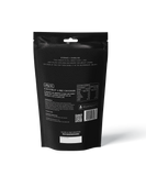 A black resealable pouch of outdoor gourmet’s Coconut Lime Chicken - Heat & Eat Meal displays product info, nutrition facts, a QR code, and cooking instructions—with a zesty kaffir lime hint—ideal camping food.