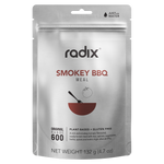 A silver package labeled "Radix Original 600kCal Smokey BBQ Meal," plant-based and gluten-free, 132 g, with cooking instructions to add water. This ready-made meal uses freeze-drying technology for easy preparation and lasting freshness.