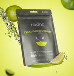 A package of Radix Ultra 800kCal Thai Green Curry Meal against a yellow background, with a splash of water and lime slices. The 144g meal is designed for highly active individuals with increased energy demands and is labeled as an all-natural, gluten-free option from Radix that’s ready in under 5 minutes.