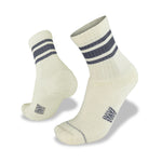 The Wilderness Wear Half Beast Sock by Wilderness Wear is an off-white Merino wool pair featuring two dark stripes near the top, shown with one upright and one angled—ideal men’s hiking socks for superior comfort and durability.