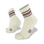 The Wilderness Wear Half Beast Sock by Wilderness Wear is a cream Merino wool pair with two brown stripes near the top, shown from side and back angles on a plain white background.
