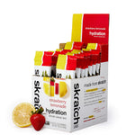 Skratch Labs Sport Hydration Drink Mix Single Serving 20-Pack—ideal for electrolyte replacement, with strawberry lemonade flavor, lemon slice, and strawberry pictured in front.