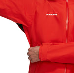 A person wearing a bright red Mammut Alto Light HS Men's jacket pulls the front zipper up.