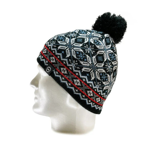 The Domex Beanie by Domex features a black and white knit pattern, red accents, and a pom-pom top. Displayed on a white mannequin head, this stylish beanie is perfect for your winter hats collection.
