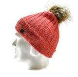 A mannequin head showcases the Domex Beanie by Domex, featuring a ribbed pink knit, folded brim, and faux fur pom-pom—one of our coziest options for winter hat collections.