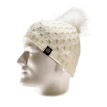 The Domex Beanie by Domex is a white knit hat with a pom-pom, shown on a white mannequin head and accented with a small black logo tag—ideal for anyone seeking stylish winter headwear.