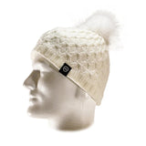 The Domex Beanie by Domex is a white knit hat with a pom-pom, shown on a white mannequin head and accented with a small black logo tag—ideal for anyone seeking stylish winter headwear.