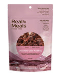 A pink packet of Real Meals - Chocolate Cake Pudding, by Real Meals, displays an image of moist chocolate cake pudding covered in creamy chocolate sauce, along with product details on the front.