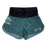 T8 Women's Sherpa Shorts in green and black feature printed patterns and the "A T8" logo, providing bounce-free comfort. Ideal for individuals looking for lightweight running shorts.