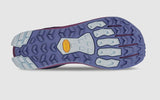 The image shows the sole of the Altra Women's Lone Peak 9+ Trail Runners, featuring a blue and purple tread pattern with a yellow Vibram® Megagrip logo in the center.