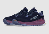 Altra Women's Lone Peak 9+ Trail Runners by Altra, shown in dark blue and purple with a white logo, feature rugged Vibram® Megagrip soles and an Altra EGO™ midsole, displayed on a plain background.