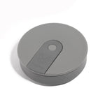 The Hunu Collapsible Cup by Hunu is a grey, round, flat cup featuring a central button and subtle animal logo, shown against a white background.