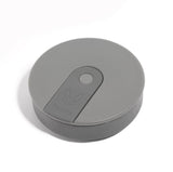 The Hunu Collapsible Cup by Hunu is a grey, round, flat cup featuring a central button and subtle animal logo, shown against a white background.