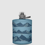 The HydraPak Hydrapak Stow Bottle 500ML is a blue collapsible bottle with dark and light blue mountain range graphics, featuring a spill-proof nozzle for easy, mess-free hydration.