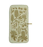 The Mont Flora Microfibre Travel Towel by Mont is a beige towel adorned with green botanical illustrations, showcasing a variety of flowers and leaves, laid flat with a hanging loop on the side. Made from recycled polyester for fast drying, this elegant piece embodies the practicality of microfibre travel towels.