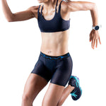 A woman in athletic wear, including T8 Women's Commandos Running Underwear by T8, is captured mid-stride as if running or exercising.