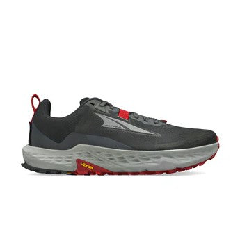 The Altra Men's Timp 5 is a dark gray and black trail running shoe with red accents, a thick light gray sole, and a visible yellow Vibram logo, featuring a Vibram Megagrip outsole for superior traction.