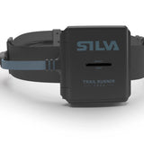 Close-up of the Silva Trail Runner Free H headlamp by Silva, featuring a black strap. The words "SAFETY LIGHT" and "TRAIL RUNNER FREE" are clearly visible on the lamp's casing, making it ideal for running in low-light conditions with its powerful Hybrid battery.