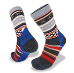 A pair of grey, blue, red, and white patterned Wilderness Wear Merino Fusion Max Socks with various geometric designs displayed on a white background, featuring reinforced heel and toe for added durability.