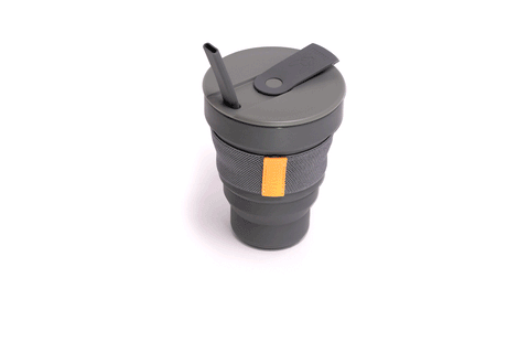 The Hunu Collapsible Cup by Hunu is a grey travel cup with a leak-proof lid, straw, BPA-free gray fabric grip, and an orange tag, shown on a white background.