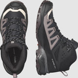 A pair of black and gray hiking boots with rugged soles. One boot is positioned sideways, displaying the brand name "Salomon" and model "Women's X Ultra 360 GTX MID," featuring All Terrain Contagrip for outdoor enthusiasts, while the other shows the top view.