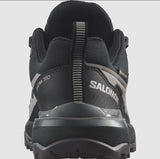 Close-up rear view of the Salomon Women's X Ultra 360 GTX hiking shoe in black, showcasing its sturdy rubber sole, breathable upper fabric, and convenient pull-tab for easy wear. Perfect for outdoor enthusiasts, it features Gore-Tex waterproof technology to keep your feet dry on any adventure.