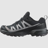 Side view of the Salomon Women's X Ultra 360 GTX, a black and gray Gore-Tex waterproof hiking shoe by Salomon, featuring a rugged sole and low-cut design with all terrain contagrip technology.