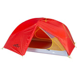 The Mont Moondance EX Tent by Mont is a red, dome-shaped camping tent with an open entrance, designed for outdoor use and constructed from durable materials. It is ideal for ultralight backpacking trips.