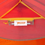 Close-up of the Mont Moondance EX Tent interior showing an emergency repair sleeve stored in a small mesh pocket near the top.