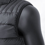 Close-up of a black 3 Peaks Women's Down Vest on a black mannequin, showcasing its sleeveless design and quilted details. This vest offers high warmth to weight ratio and is water repellent, making it perfect for various weather conditions.