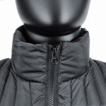 Close-up view of a black mannequin wearing the 3 Peaks Men's Down Vest, featuring a black quilted design with a high collar and a partially zipped front. The vest showcases its durable water-repellent finish and impressive warmth-to-weight ratio.