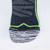 Close-up view of Wilderness Wear 10K Merino Socks in black and grey, featuring green accents on a white background, designed by Wilderness Wear with merino wool for breathable performance.