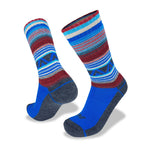 Two colorful Wilderness Wear Merino Fusion Max Socks by Wilderness Wear featuring a pattern of blue, red, and white stripes with geometric designs, and darker blue reinforced heel and toe sections.
