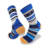 The Wilderness Wear Merino Fusion Max Socks, by Wilderness Wear, boast lively geometric patterns in blue, orange, white, and black and are designed with a reinforced heel and toe to enhance durability.