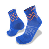 A pair of Wilderness Wear Atmosphere Q Trail Socks in blue with orange and white geometric patterns and "WILDERNESS" on the cuff, featuring moisture management, displayed on a white background.