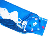 Close-up of the T8 Ice Bandana in blue, showcasing white, red, and navy patterns with snap buttons for secure fit—designed by T8 for running comfort and trail-tested reliability.