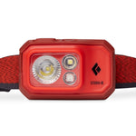 A waterproof red Black Diamond Storm 500 Rechargeable Headlamp with a black strap for outdoor lighting.
