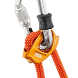 A close-up of a Petzl Connect Adjust carabiner used for sport climbing.