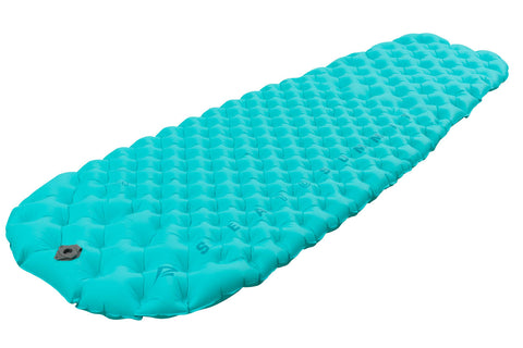 A turquoise Sea to Summit Comfort Light Air Sprung Mat features a honeycomb pattern with Air Sprung Cells and a multi-function high flow-rate valve on one end.
