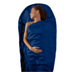 A person sleeps wrapped in a Sea to Summit Silk Liner Stretch Mummy, enhancing thermal efficiency against a white background.