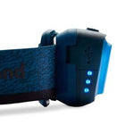 Close-up of the Black Diamond Astro 300 Rechargeable Headlamp, featuring a blue exterior with an adjustable strap and three blue LED lights. The design closely resembles other high-quality Black Diamond headlamps. A USB port is visible on the device, highlighting its rechargeable feature and its capability to deliver up to 300 lumens of bright light.